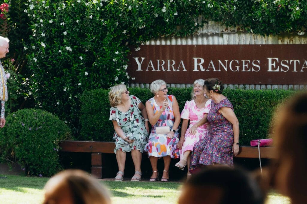 Friends laugh in colourful dresses at Yarra Ranges Estate