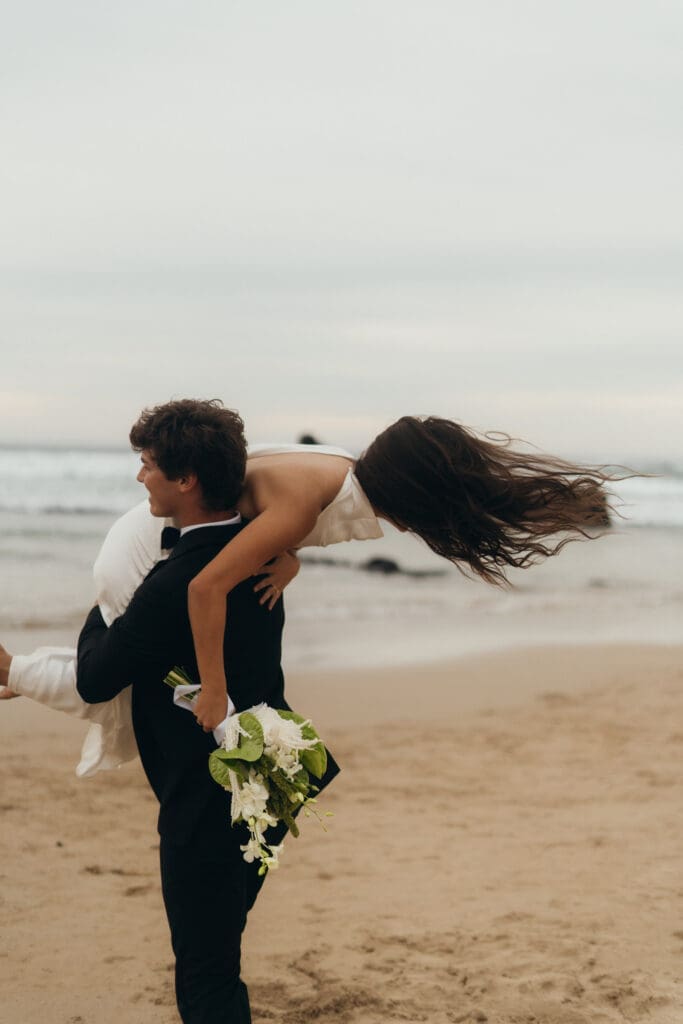 Phillip Island and Gippsland Wedding photography and content creation available from Ebb and Flow Photography. Bride over shoulder, husband lifts his wife, couple portraits, fun couples portrait.