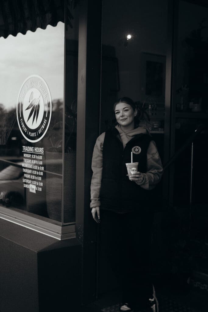 Mim with her favourite coffee from 3818 Cafe standing out the front of The Willow Branch, The best florist in Gippsland and Melbourne. Captured by Ebb and Flow Photography