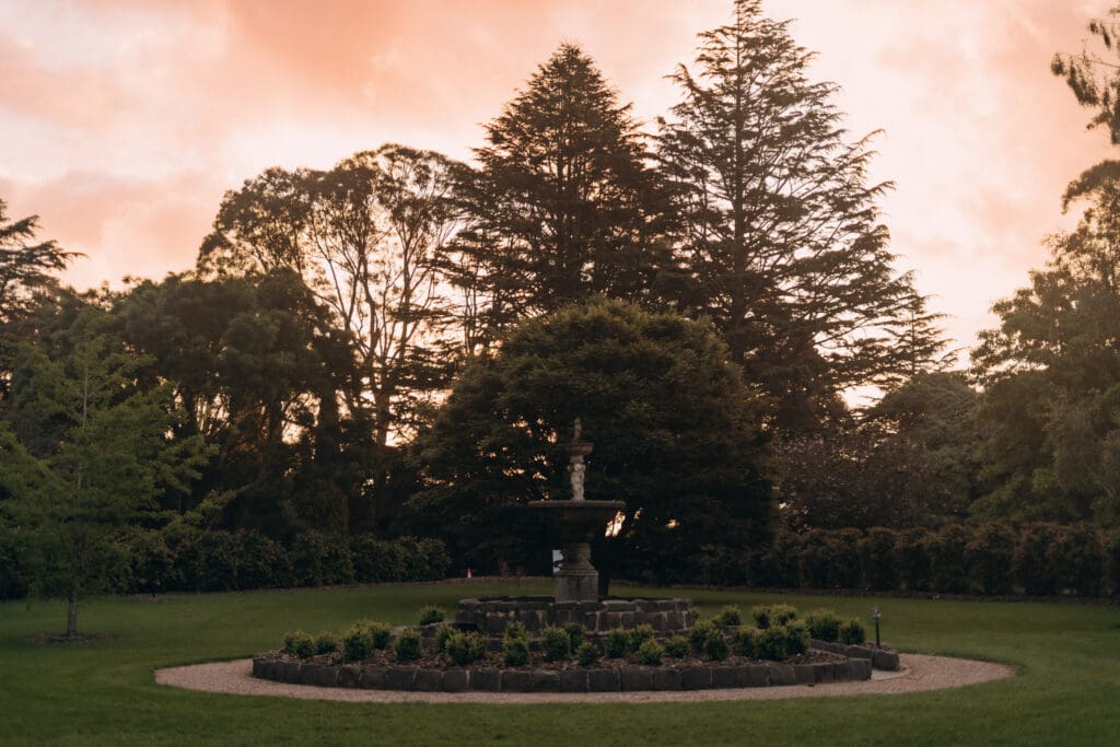 Stone water fountain surrounded by immaculate lawns at Glenfyne Weddings in Gippsland, photo by Ebb and Flow Photography