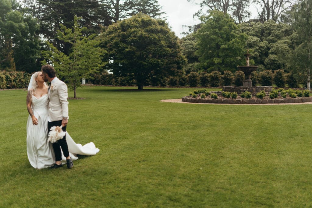 Stone water fountain surrounded by immaculate lawns at Glenfyne Weddings in Gippsland, photo by Ebb and Flow Photography